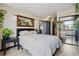 Cozy main bedroom with natural light, decorative mirror, and ensuite access at 1301 Speer Blvd # 1108, Denver, CO 80204