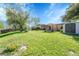 Large, green backyard with a shed, pergola, and patio offering ample space for recreation and relaxation at 6018 Owens St, Arvada, CO 80004