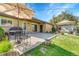 Enjoy this brick backyard, perfect for entertaining, with shade, furniture, and an outdoor grill at 6018 Owens St, Arvada, CO 80004
