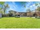 Expansive backyard featuring a lush green lawn, patio area, gazebo and mature landscaping perfect for outdoor entertaining at 6018 Owens St, Arvada, CO 80004