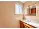 Bathroom featuring vanity, sink, and decorative mirror at 6018 Owens St, Arvada, CO 80004