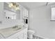The clean bathroom features a bright vanity, modern mirror, and decorative hanging light fixture at 6018 Owens St, Arvada, CO 80004