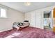 Bedroom featuring carpet, a bed, and closet at 6018 Owens St, Arvada, CO 80004