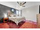 Cozy bedroom with ceiling fan, carpeting, and large windows for natural light at 6018 Owens St, Arvada, CO 80004