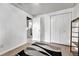 A bright bedroom offers closet space, neutral paint, and access to the laundry room at 6018 Owens St, Arvada, CO 80004