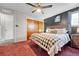 Bedroom features carpeting, ceiling fan, and spacious closets at 6018 Owens St, Arvada, CO 80004