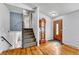 Inviting entryway featuring hardwood floors, a staircase, and a vintage grandfather clock at 6018 Owens St, Arvada, CO 80004
