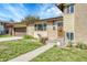 Close-up view of the home's entrance, showcasing the brick facade and well-kept lawn at 6018 Owens St, Arvada, CO 80004