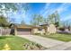 Charming single-Gathering home with brick accents, mature trees, and a well-manicured lawn at 6018 Owens St, Arvada, CO 80004
