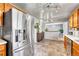 View of kitchen featuring stainless steel refrigerator and natural wood cabinets at 6018 Owens St, Arvada, CO 80004