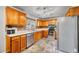Functional kitchen featuring oak cabinets, stainless steel appliances, and a well-lit workspace at 6018 Owens St, Arvada, CO 80004