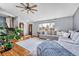 Cozy living room featuring hardwood floors, large windows, and an inviting sectional sofa at 6018 Owens St, Arvada, CO 80004