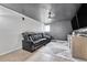 A stylish living room includes a modern leather couch, plush rug, and a mounted television at 6018 Owens St, Arvada, CO 80004