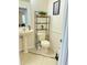 Compact bathroom featuring a pedestal sink and toilet with shelving at 21561 E 48Th Pl, Denver, CO 80249