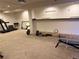 Spacious basement gym boasts soft carpet and abundant workout equipment for fitness enthusiasts at 21561 E 48Th Pl, Denver, CO 80249