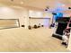 Bright basement gym features durable carpet, large mirror, workout equipment, and a mounted projector at 21561 E 48Th Pl, Denver, CO 80249