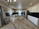 Open kitchen with white cabinets, black granite counters, island and stainless steel appliances at 21561 E 48Th Pl, Denver, CO 80249