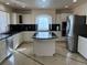 Bright kitchen with white cabinets, granite countertops, stainless steel appliances, and island at 21561 E 48Th Pl, Denver, CO 80249