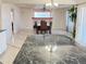 Kitchen island and dining room with great lighting and hardwood furniture at 21561 E 48Th Pl, Denver, CO 80249