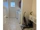 Functional laundry room with washer, dryer, and storage space at 21561 E 48Th Pl, Denver, CO 80249
