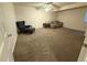 Cozy carpeted living room offers comfortable seating with a couch and armchair for relaxation at 21561 E 48Th Pl, Denver, CO 80249