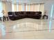 Spacious living room with tile flooring, large sectional sofa, and elegant chandelier at 21561 E 48Th Pl, Denver, CO 80249
