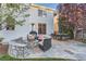 Outdoor patio area featuring a stone fire pit, seating, and dining table, ideal for entertaining guests at 11013 Valleybrook Cir, Highlands Ranch, CO 80130