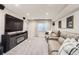 Cozy basement rec room featuring a fireplace, large screen television, and comfortable seating at 11013 Valleybrook Cir, Highlands Ranch, CO 80130