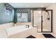 Bright bathroom featuring a soaking tub, tiled shower, and stylish window treatments for a spa-like experience at 11013 Valleybrook Cir, Highlands Ranch, CO 80130