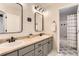 Stylish bathroom boasts double sinks, modern fixtures, and unique floor tiling for a contemporary feel at 11013 Valleybrook Cir, Highlands Ranch, CO 80130