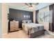 Comfortable bedroom with a decorative accent wall, ceiling fan, and plenty of natural light from the window at 11013 Valleybrook Cir, Highlands Ranch, CO 80130