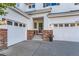 Inviting entrance with well-manicured steps, a colorful flower pot, and a two-car garage at 11013 Valleybrook Cir, Highlands Ranch, CO 80130