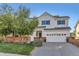 Charming two-story home with red brick accents, green lawn, and a well-maintained yard at 11013 Valleybrook Cir, Highlands Ranch, CO 80130