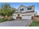 Attractive two-story home featuring a three-car garage, lush lawn, and inviting curb appeal at 11013 Valleybrook Cir, Highlands Ranch, CO 80130