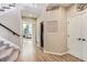 Open hallway with staircase, light wood floors, and natural light filtering through nearby rooms at 11013 Valleybrook Cir, Highlands Ranch, CO 80130
