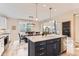 Modern kitchen with an island, dining area, bright light, and stainless steel appliances at 11013 Valleybrook Cir, Highlands Ranch, CO 80130