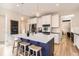 Well-designed kitchen with white cabinets, an island with seating, and stainless steel appliances at 11013 Valleybrook Cir, Highlands Ranch, CO 80130