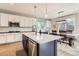 Open kitchen with a large island, stainless steel appliances, white cabinets, and an adjacent dining area at 11013 Valleybrook Cir, Highlands Ranch, CO 80130