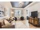 Stylish living room with modern decor, gray hardwood floors, and tray ceiling with contemporary lighting at 11013 Valleybrook Cir, Highlands Ranch, CO 80130