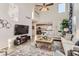 Open-concept living room with high ceilings, stylish decor, and a view of the kitchen at 11013 Valleybrook Cir, Highlands Ranch, CO 80130