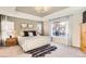 Bright main bedroom features a plush rug, a large bed, and lots of natural light at 11013 Valleybrook Cir, Highlands Ranch, CO 80130