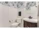 Charming powder room featuring wainscoting, stylish wallpaper, and modern fixtures at 11013 Valleybrook Cir, Highlands Ranch, CO 80130