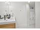 Basement bathroom with a double vanity, white towels, and a mosaic tile floor at 7746 S Gray St, Littleton, CO 80128