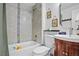 Clean bathroom with a tub, shower, toilet, and a vanity with a wood cabinet at 7746 S Gray St, Littleton, CO 80128