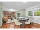 Bright dining area with wood floors, and view into a living room with fireplace at 7746 S Gray St, Littleton, CO 80128