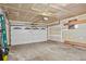 Unfinished garage with an automatic door and ample storage at 7746 S Gray St, Littleton, CO 80128