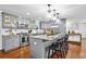 Modern kitchen with gray cabinets, granite island, and stainless steel appliances at 7746 S Gray St, Littleton, CO 80128