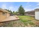 Spacious backyard deck with built-in seating and fire pit, surrounded by mature trees and a fenced yard at 4629 Estes St, Wheat Ridge, CO 80033