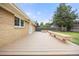 Spacious backyard deck with built-in seating, fire pit and view of the fenced yard at 4629 Estes St, Wheat Ridge, CO 80033