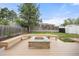 Backyard with a fire pit in the middle of a sitting area on a wooden deck at 4629 Estes St, Wheat Ridge, CO 80033